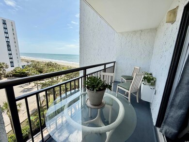 Balcony featuring a beach view and a water view