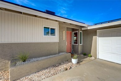 Doorway to property featuring stucco siding, concr