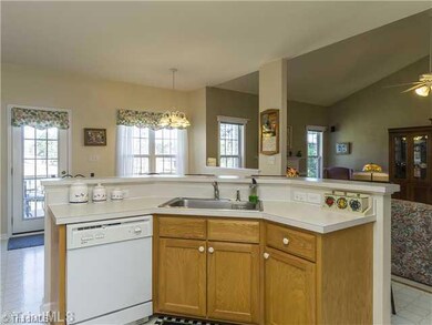 Kitchen. The raised eating bar makes for additional seating and the two pantries maximize kitchen storage.