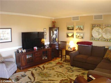 Living Room - Hardwoods, chair & crown molding!