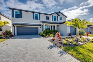 Traditional home with a garage, decorative drivewa