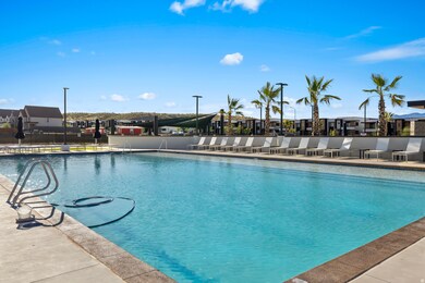 Community pool with a patio area and a residential view