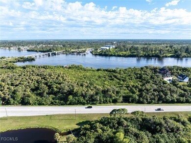 Drone / aerial view of a notable bridge and a large body of water