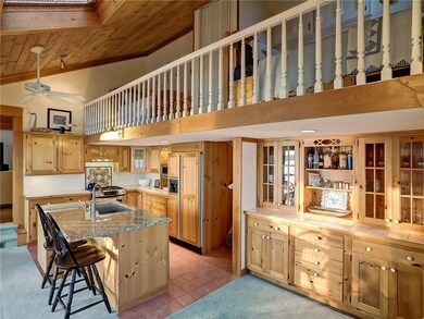 Kitchen with new granite island and sleeping loft 