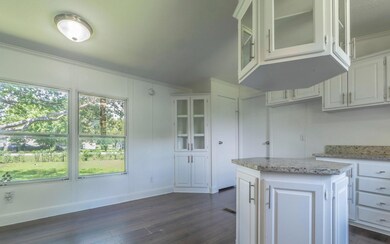 Kitchen featuring dark wood finished floors, crow