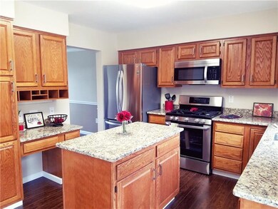 Kitchen features new granite, stove, refrigerator,