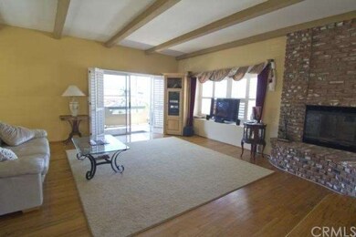 Living room with fireplace, leading out to west fa