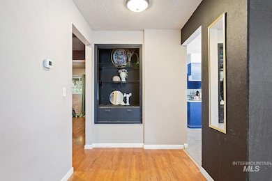 Corridor featuring wood finished floors and a textured ceiling