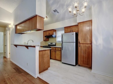 Kitchen with freestanding refrigerator, gas range