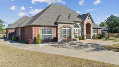 Driveway goes around to garages in back of house