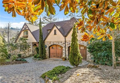 Nestled into its lot, with cobblestone driveway an