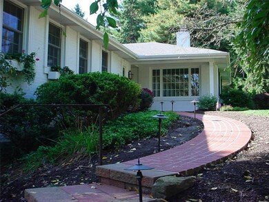 Welcoming curved lit sidewalk leading to the front