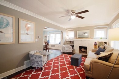 Another view of the living room.  The living room retains original windows with character although replacement windows have been added in the other rooms.