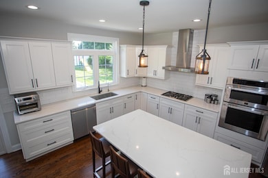 A fresh perspective on this beautifully designed kitchen—showcasing the double oven, stainless steel appliances, and modern finishes throughout. The open layout and clean lines create a perfect blend of style and function.