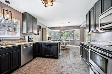 Updated Kitchen – Granite countertops, stainless steel appliances, and abundant cabinet space combine style and function.