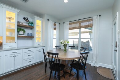 Breakfast room with wood like tile floors and custom buffets cabinet