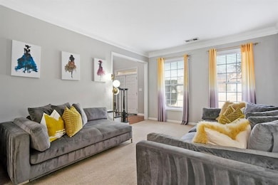 Carpeted living room featuring ornamental molding