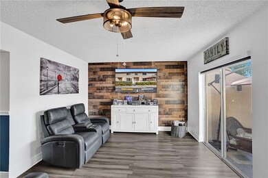 LIVING ROOM WITH SLIDERS OUT TO THE FRONT PATIO