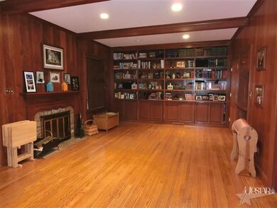 Wood floor in the family room with cherry wood wal