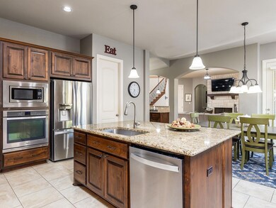Kitchen with light stone counters, a kitchen isla