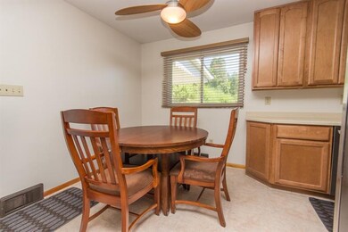 Dining area with ceiling fan in this remodeled kit