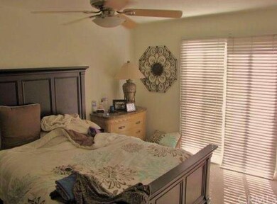 Master bedroom with ceiling fan and light fixture.
