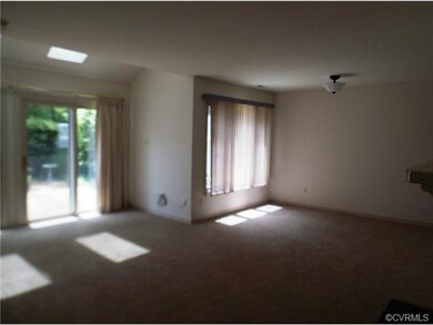 Living room with 2 sets of sliding doors to patio.