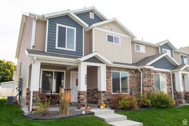 Craftsman inspired home featuring a front yard, covered porch, and stone siding