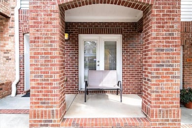 Entrance to property with brick siding