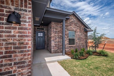 Property entrance featuring brick siding