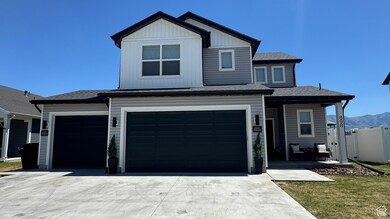 View of front of property with concrete driveway, roof with shingles, and an attached garage