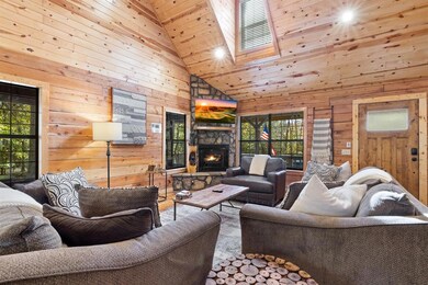 Living room featuring high vaulted ceiling, wood w