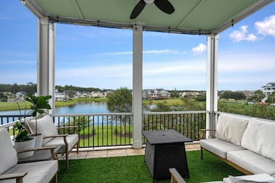 Sunroom featuring a water view and ceiling fan