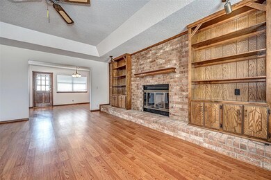 Unfurnished living room featuring a brick fireplac