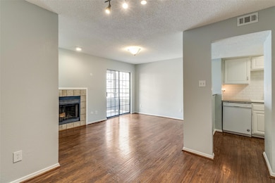 Unfurnished living room featuring baseboards, dark