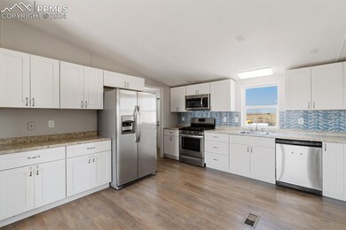 Kitchen featuring lofted ceiling, backsplash, whit