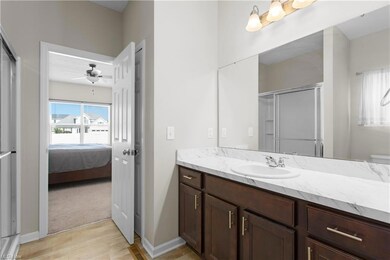 Bathroom with ceiling fan, oversized vanity, mirro