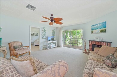Living room featuring a textured ceiling, carpet f