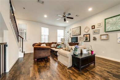 Living room featuring stairway, dark wood-style flooring, recessed lighting, and a ceiling fan