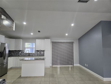 Kitchen featuring stainless steel fridge with ice