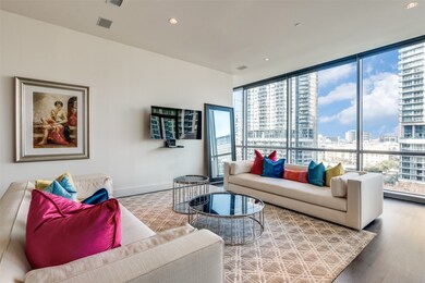 Living area with a wall of windows, recessed lighting, and wood finished floors