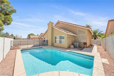 View of swimming pool with a fenced backyard and a