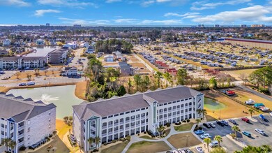 Birds eye view of property with a water view