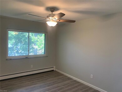 Unfurnished room with a baseboard heating unit, ha
