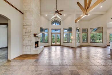 Unfurnished living room featuring a ceiling fan, 