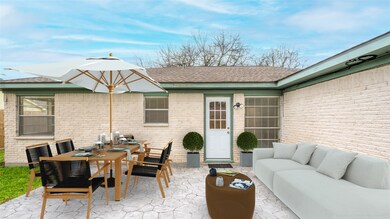 The stamped cement patio is accessed off of the home's Den. Window to left of door is Kitchen and the window on far left is Dining Room. The perfect hang out spot for morning coffee or evening wine! PHOTO VIRTUALLY STAGED.