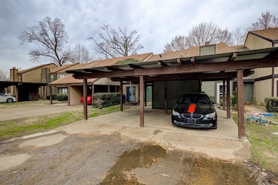 View of parking / parking lot with a carport