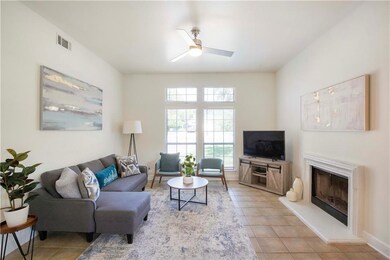 Living room with visible vents, light tile patter