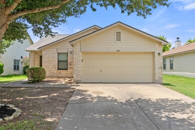 Single story home featuring stone siding, drivewa