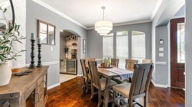 Dining space with dark wood-type flooring and crow